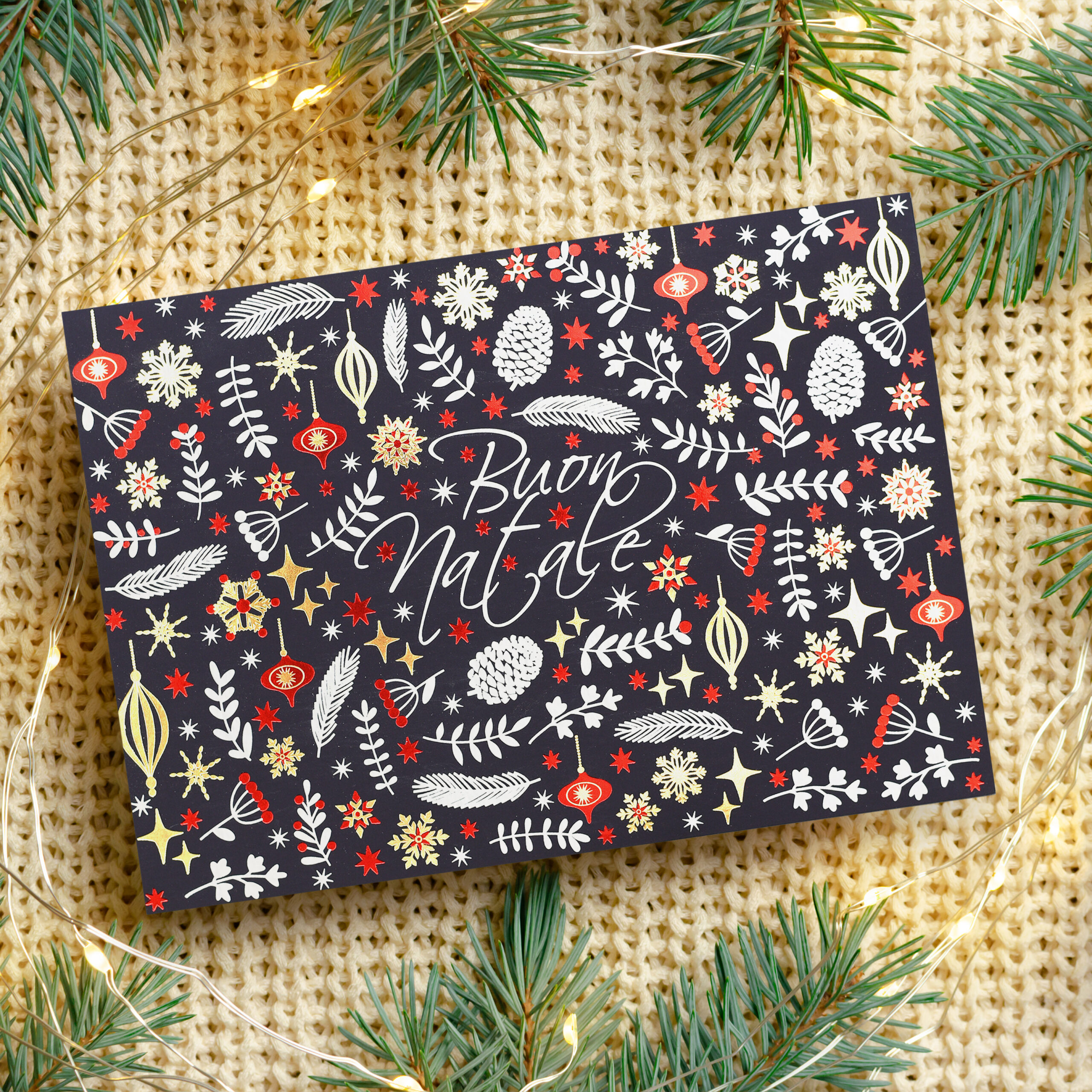 Christmas greeting card mockup with garland lights and fir tree branches on knitted background